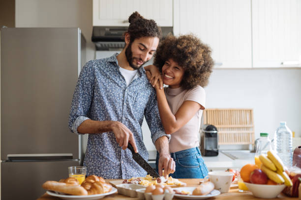istock Romantic multiracial heterosexual couple in kitchen preparing food 2035094001
