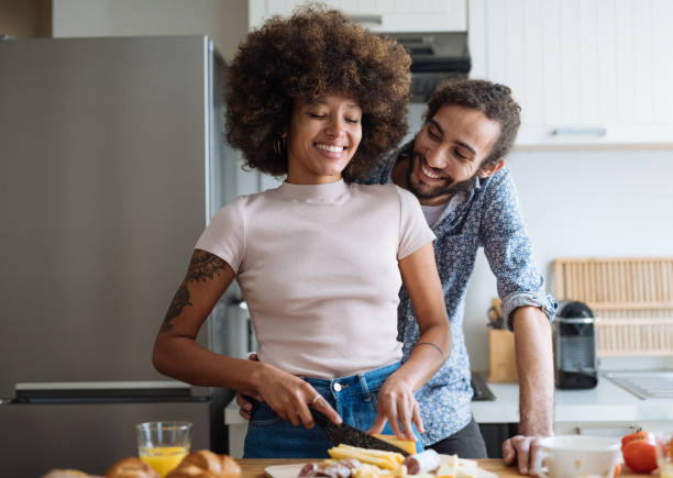 istock Lovely multiracial heterosexual couple in kitchen preparing breakfast 2035094533