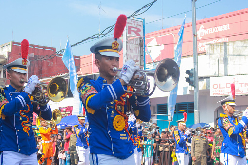 Banjar City, Indonesia - Feb 24, 2024: IPDN Bandung marching band group in action at the carnival on the town's birthday.