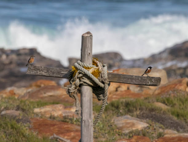 A wooden cross stands alone