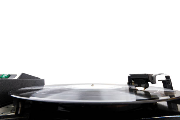 Close up of turntable needle on a vinyl record. Turntable playing vinyl. Needle on rotating black vinyl.
