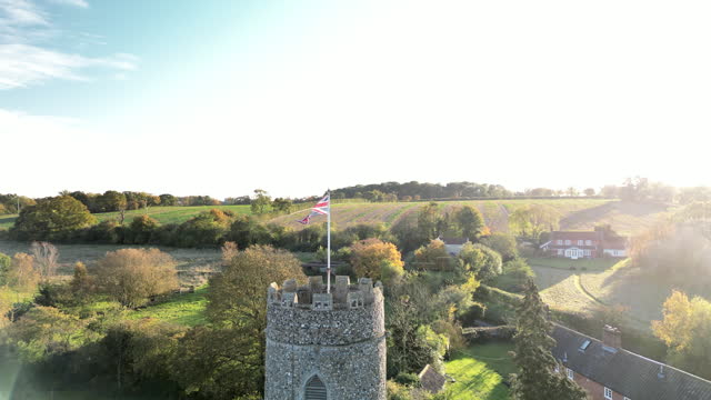 (dolly in) The Union Jack Flag on top of a Round Church Tower