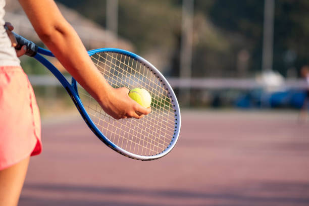 gros plan sur une fille tenant une raquette et une balle de tennis. - tennis child athlete sport photos et images de collection