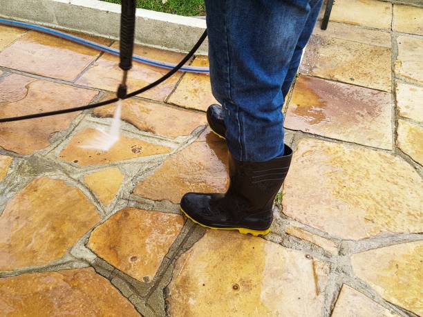 istock Man cleaning the sidewalk. 2035158700