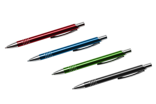 Red, blue, green and black ballpoint pens isolated on white.