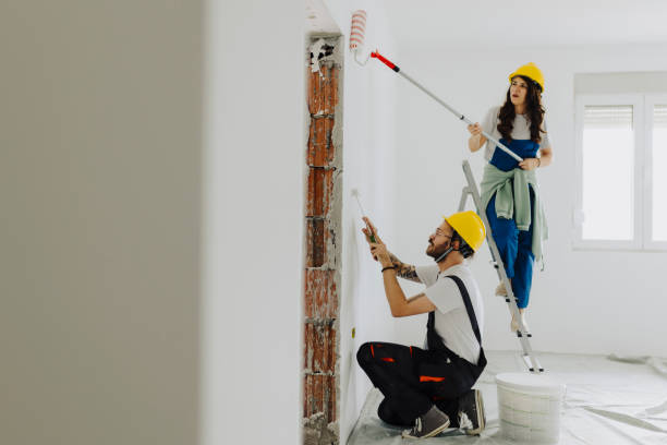 istock Young workers with painting tools indoors. Room renovation 2035239801