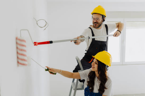 istock Young workers with painting tools indoors. Room renovation 2035246660