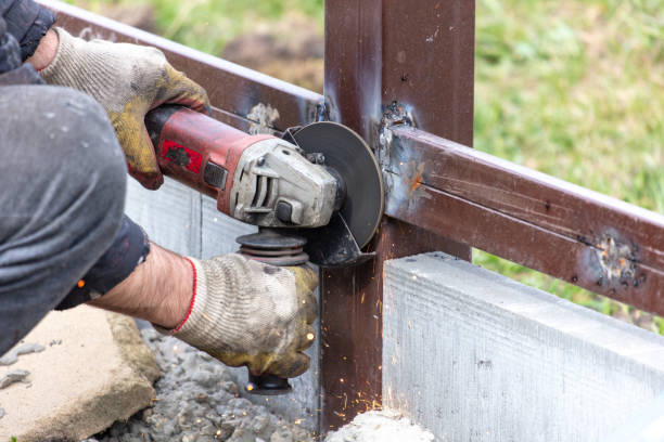 istock A worker is cutting metal to install a fence 2035267137