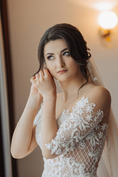 istock Beautiful brunette bride clutches an earring. 2035277349