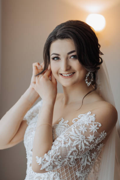 istock Beautiful brunette bride clutches an earring. 2035277350