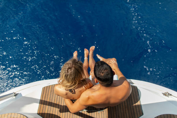 istock Young couple sitting on a yacht stern while sailing 2035285619