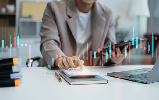 Businessman doing finances and calculate on desk about cost at office.