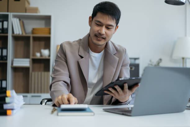 istock Businessman doing finances and calculate on desk about cost at office. 2035288255