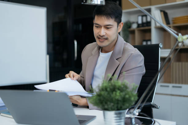 istock Young businessman working at home with tablet and documents on table. 2035288267
