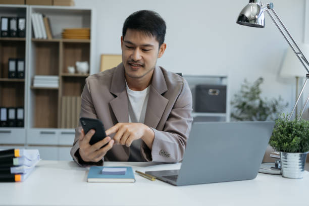 istock Email notification concept, Male use smartphone and laptop receive message alert in the mailbox. 2035288561