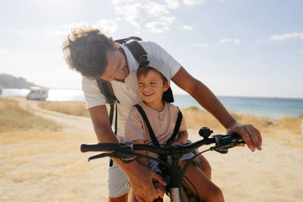 istock Father and son exploring the coastline on a bicycle 2035321525