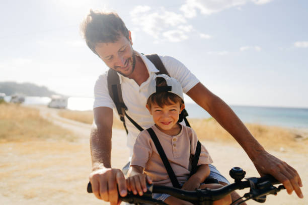 istock Father and son exploring the coastline on a bicycle 2035321539