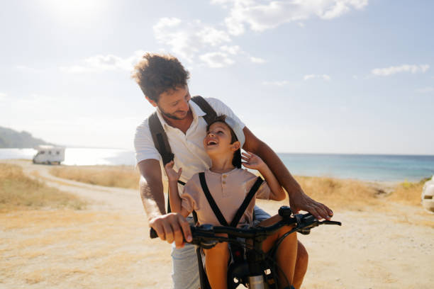 istock Father and son exploring the coastline on a bicycle 2035322048
