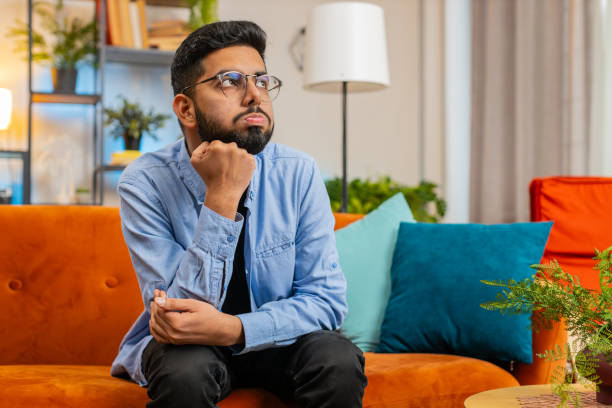 istock Thoughtful Indian man suffers from unfair situation break up depressed feeling bad annoyed burnout 2035323641