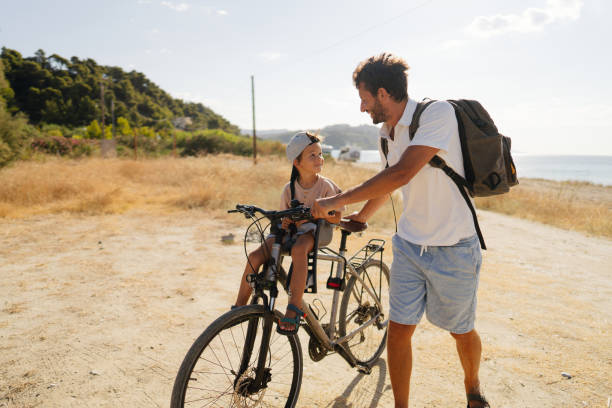 istock Father and son exploring the coastline on a bicycle 2035323655