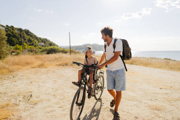 istock Father and son exploring the coastline on a bicycle 2035324184
