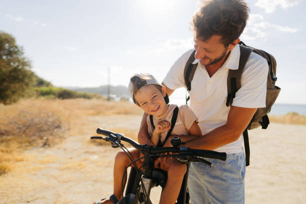 istock Father and son exploring the coastline on a bicycle 2035324742