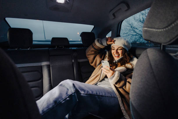 istock Woman using phone in taxi 2035327443