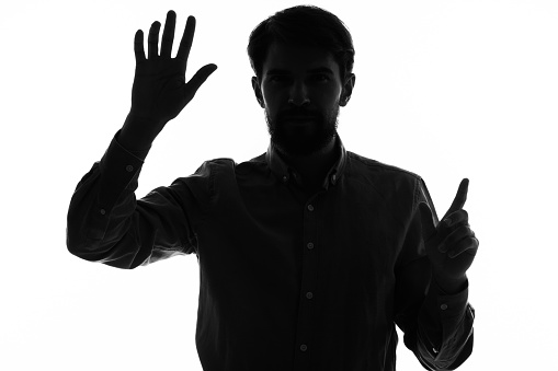 silhouette of a man and gesturing with his hands emotions mystic. High quality photo