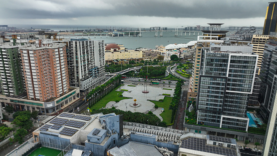 An aerial photograph capturing a panoramic view of Macao City from a high-rise building, showcasing the urban landscape and architectural marvels.
