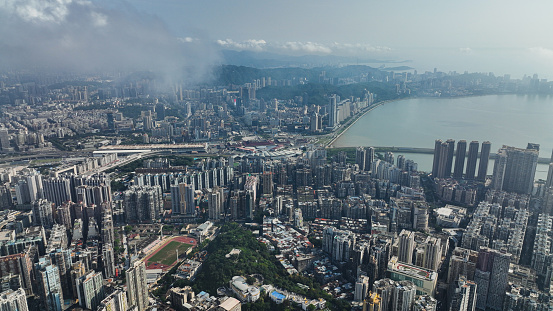 An expansive aerial perspective captures the bustling cityscape and winding river of Macao.