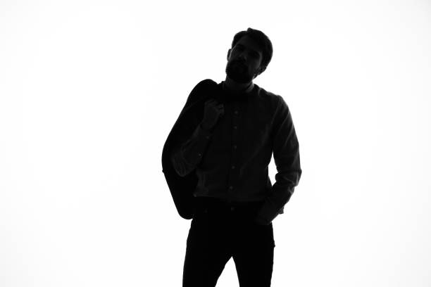 istock man in a suit detective crime light background shadow incognito 2035350391