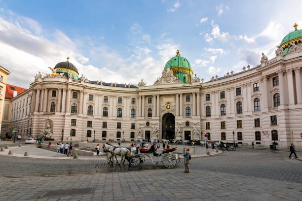 Vienna, Austria — September 27, 2015: statue of Prince Eugene of Savoy on Heldenplatz and facade of Neue Burg in Hofburg Palace, Vienna, Austria. New Castle wing today houses a number of museums and reading rooms of Austrian National Library