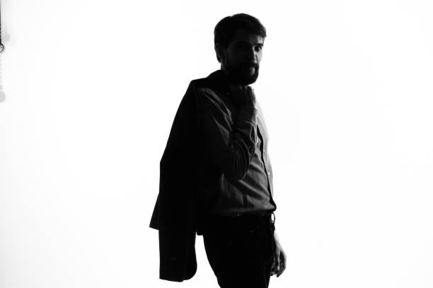 man in a suit detective crime light background shadow incognito. High quality photo