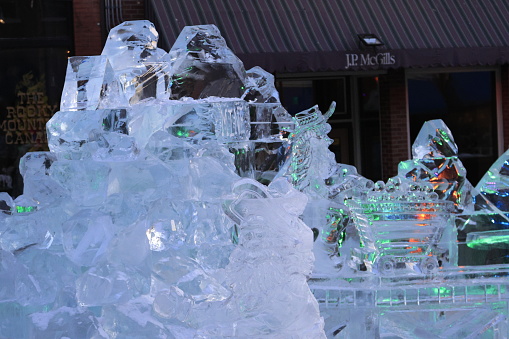 Spectators viewing the 2024 Cripple Creek Ice Festival on Bennet Avenue in Cripple Creek Colorado with Ice sculptures lining the street