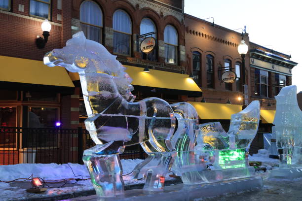 Spectators viewing the 2024 Cripple Creek Ice Festival on Bennet Avenue in Cripple Creek Colorado with Ice sculptures lining the street