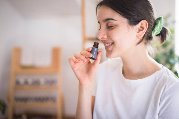 istock Young girl smelling essential oil 2035354780