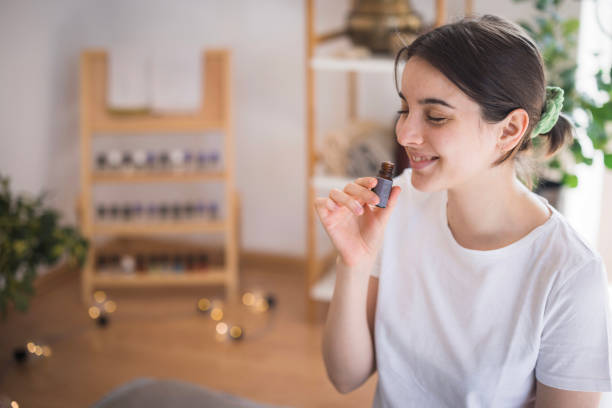 istock Young girl smelling essential oil 2035354799