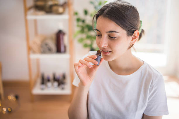 istock Young girl smelling essential oil 2035354846