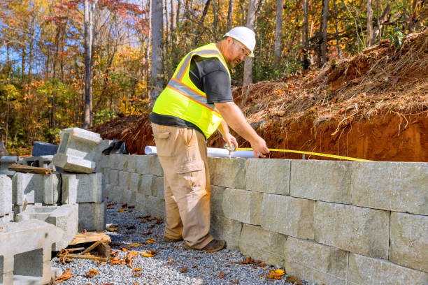 istock In course of mounting retaining walls by cement blocks, construction a workers studied blueprints 2035357048