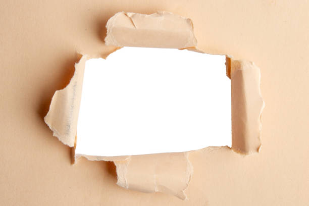 istock Kraft paper, torn in the middle with an empty hole. And an empty background behind 2035358119