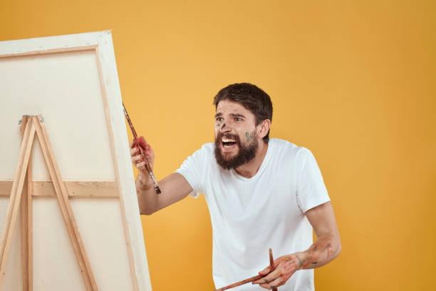 Bearded male artist easel for drawing art palette. High quality photo
