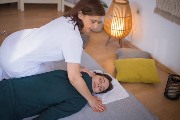 istock Therapist performing shiatsu massage on a patient 2035373232