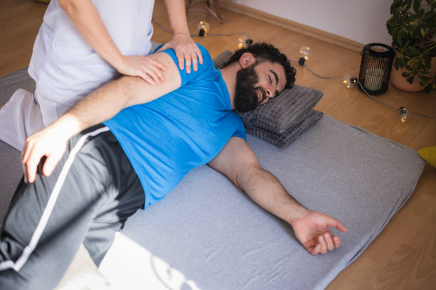 istock Therapist performing shiatsu back massage on a patient 2035377600