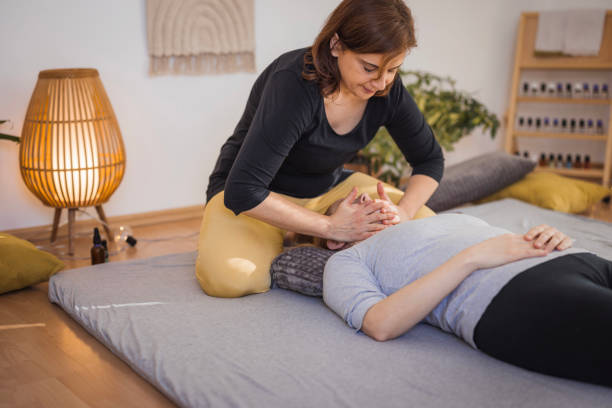 istock Therapist performing a shiatsu massage on patient's face 2035377624