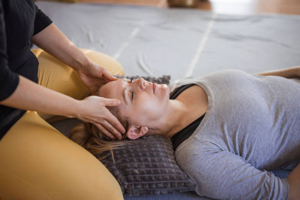 istock Therapist massaging pressure points on a patient's face 2035378176