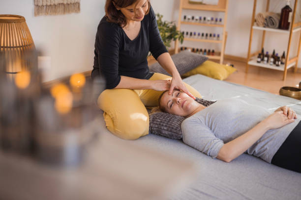 Woman getting face massage during shiatsu therapy