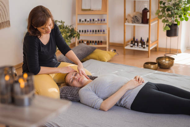 istock Woman getting face massage during shiatsu therapy 2035380325