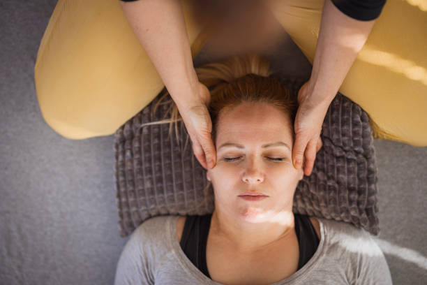istock Therapist massaging pressure points on a patient's face 2035382035