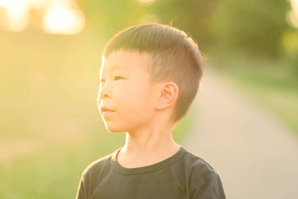 istock Adorable young boy gleefully playing in a summer park 2035393548