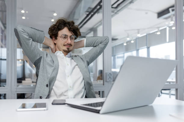 istock Confident young businessman relaxing in modern office environment 2035399072